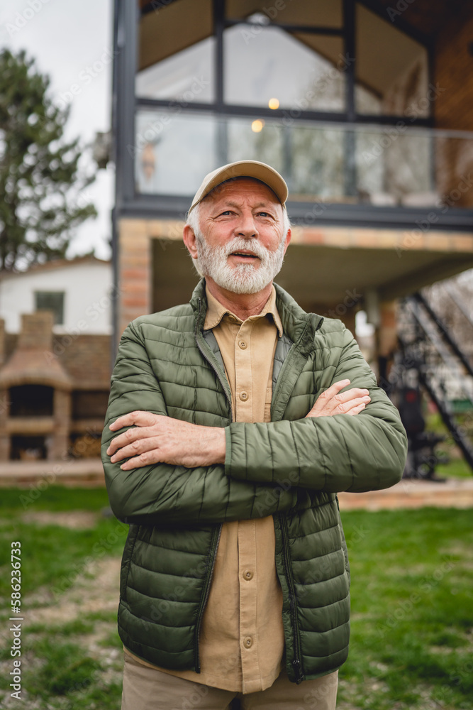 One senior man stand outdoor in front of his house happy confident One senior man stand outdoor in front of his house happy confident
