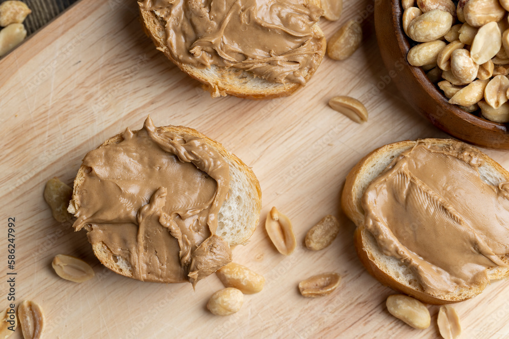 Fototapeta premium Peanut paste on a soft wheat baguette