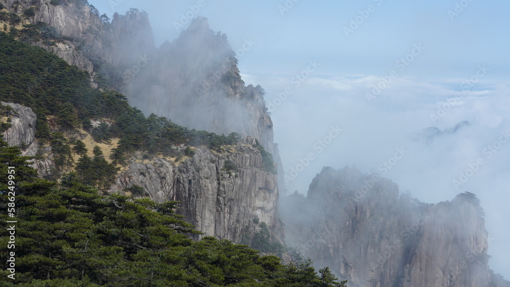 The beautiful mountains landscapes with the green forest and the erupted rock cliff as background in the countryside of the China