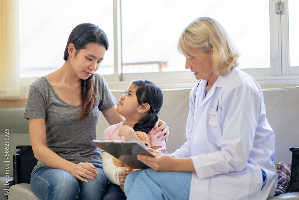 Pediatrician is closely caring and asking about sick girls symptoms, health concepts and child care. Pediatrician is closely caring and asking about sick girls symptoms, health concepts and child care.