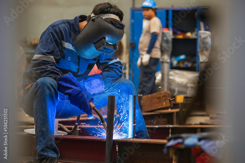 Welding male worker metal steel is part of beam structure