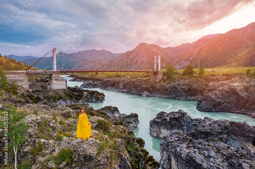 Woman in dress background landmark Oroktoysky bridge over Katun river in valley of Altai Mountains, aerial top view. Landscape Chemal Siberia, Russia photo