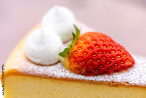 Cheese cake with strawberry on wooden table