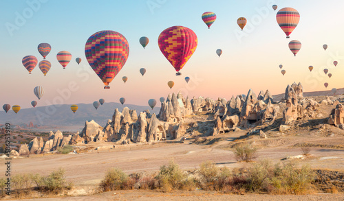 Hot air balloon flying over rock landscape at Cappadocia - Goreme, Turkey