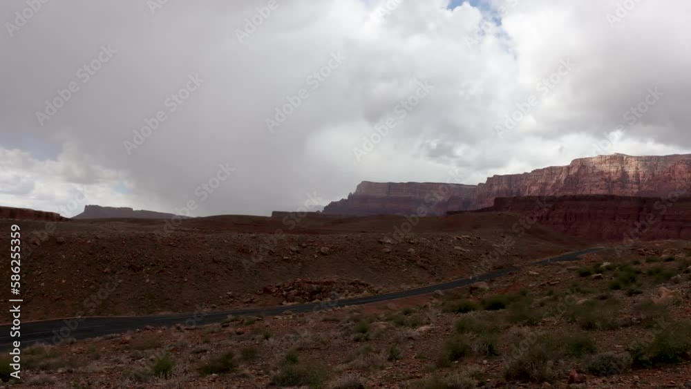 Time-lapse featuring a road and the Vermillion Cliffs with fast moving storm clouds near Lee's Ferry Arizona. Time-lapse featuring a road and the Vermillion Cliffs with fast moving storm clouds near Lee's Ferry Arizona.