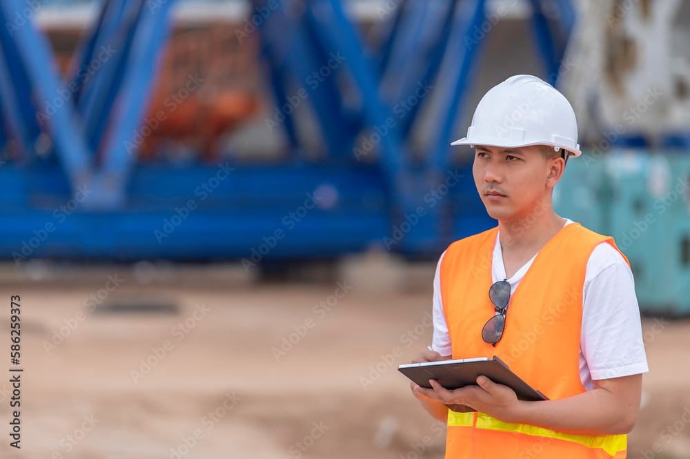 Fototapeta premium Group of asian engineers discuss about work at site of building under construction,The contractor team discusses the design of the structure,Three workers are working outside.
