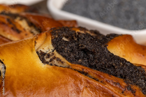 Fresh bun with poppy seed filling on the table