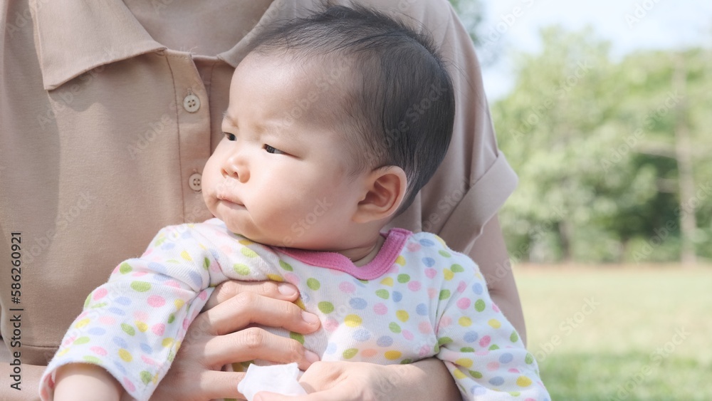 Little baby girl made funny face while her mother was holding her. Little baby girl made funny face while her mother was holding her.