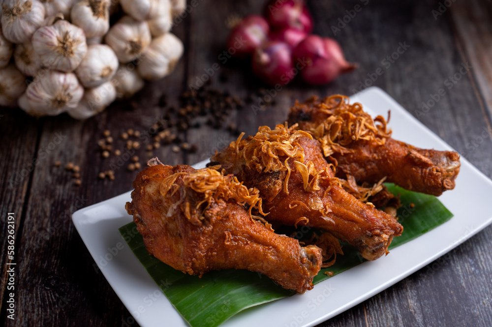 Deep fried chicken and fried onions, southern style herbs recipe on wooden table. Deep fried chicken and fried onions, southern style herbs recipe on wooden table.