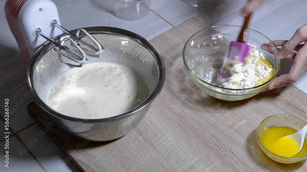 Stir the cake dough using a mixer in a metal bowl Stir the cake dough using a mixer in a metal bowl