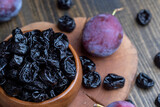 Ripe plums of dark color on the table