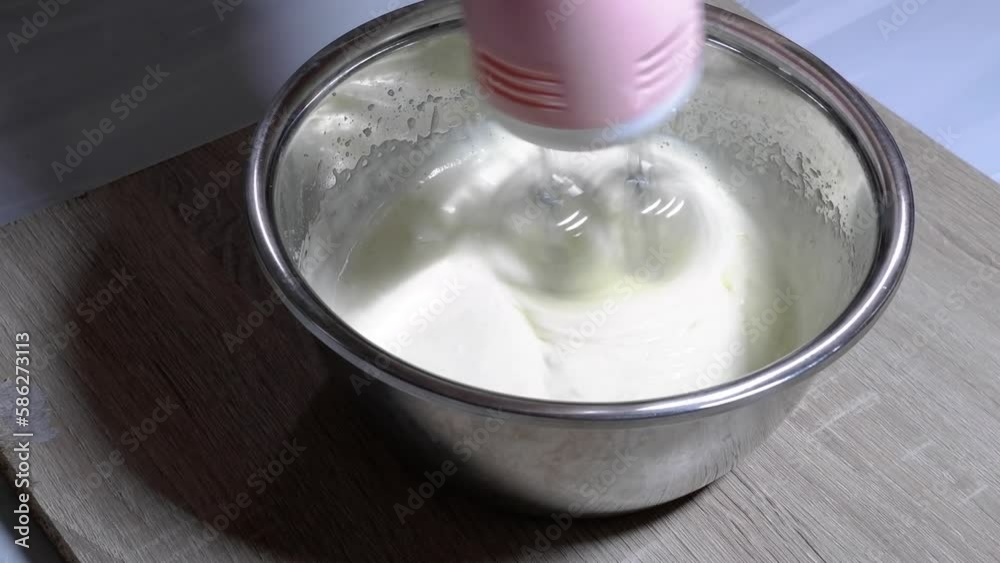 Stir the cake dough using a mixer in a metal bowl Stir the cake dough using a mixer in a metal bowl