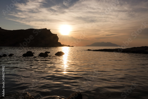 View of Samothrace island from Yildizkoy (Arcadia) beach in Imbros Island at sunset with cloudy sky. Gokceada, Çanakkale Turkey