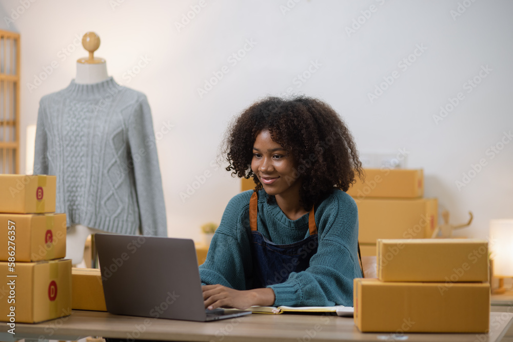 Young African American woman and online selling at home office, Startup small business owner working Online selling and product order for delivery to customer. Young African American woman and online selling at home office, Startup small business owner working Online selling and product order for delivery to customer.