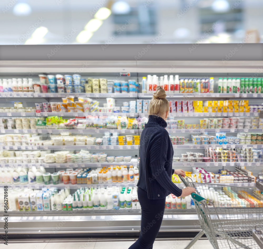 supermarket shopping,Woman choosing a dairy products at supermarket.