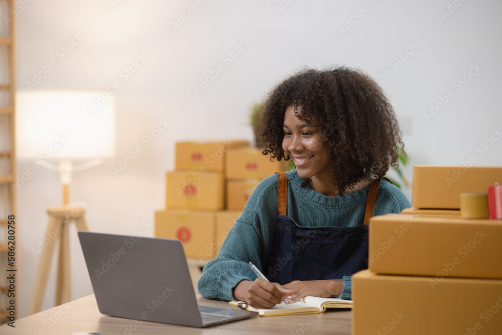Young African American woman and online selling at home office, Startup small business owner working Online selling and product order for delivery to customer. Young African American woman and online selling at home office, Startup small business owner working Online selling and product order for delivery to customer.
