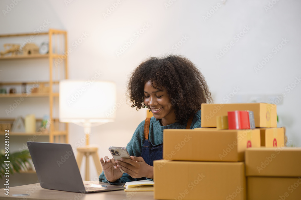 Young African American woman and online selling at home office, Startup small business owner working Online selling and product order for delivery to customer. Young African American woman and online selling at home office, Startup small business owner working Online selling and product order for delivery to customer.