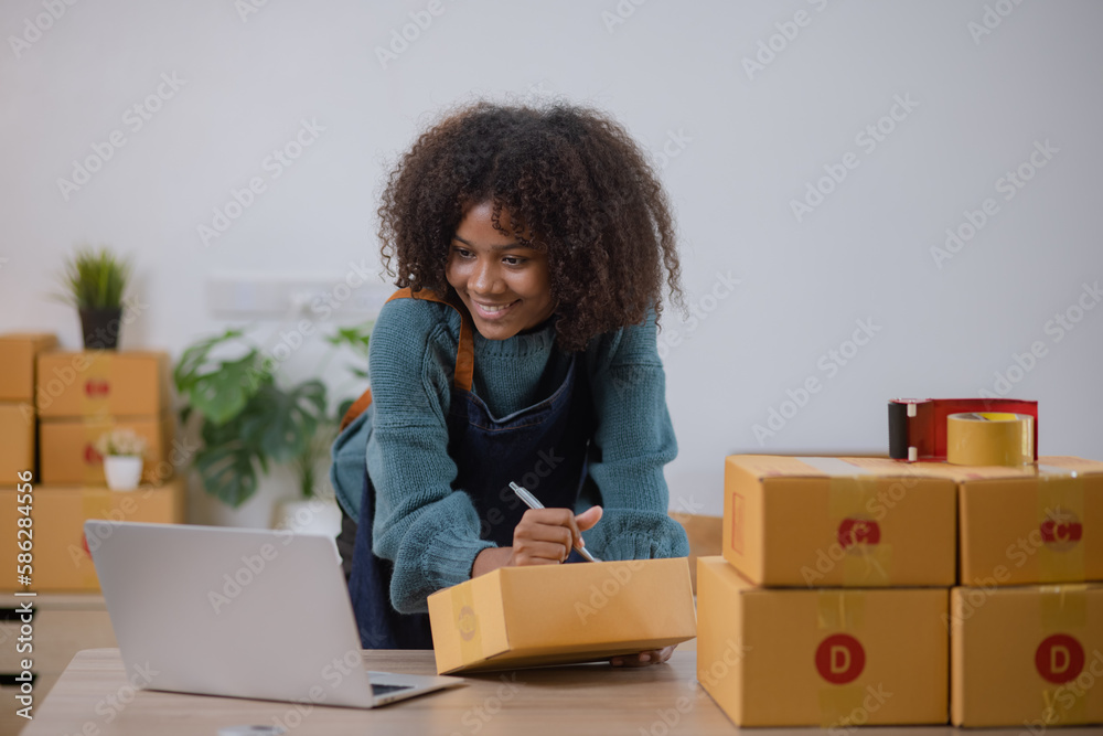 Young African American woman and online selling at home office, Startup small business owner working Online selling and product order for delivery to customer. Young African American woman and online selling at home office, Startup small business owner working Online selling and product order for delivery to customer.