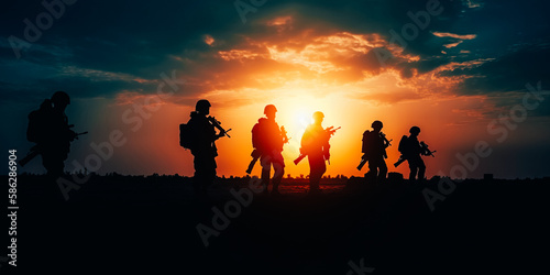 Military silhouettes of soldiers against the backdrop of sunset sky