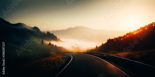 Road in the mountains at foggy sunrise