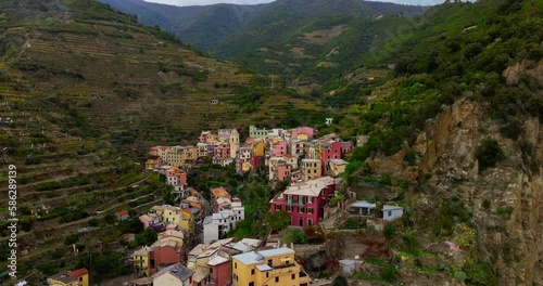 Sunset aerial view of Manarola Cinque Terre Italy Liguria famous historic town of colorful houses on the cliffs of Mediterranean Sea Drone view