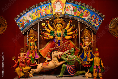Idol of Goddess Devi Durga at a decorated puja pandal in Kolkata, West Bengal, India. Durga Puja is a famous and major religious festival of Hinduism that is celebrated throughout the world. photo