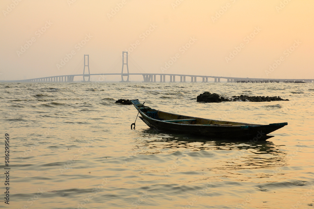 A simple wooden boat stranded in waters of the Madura Strait, East Java.
