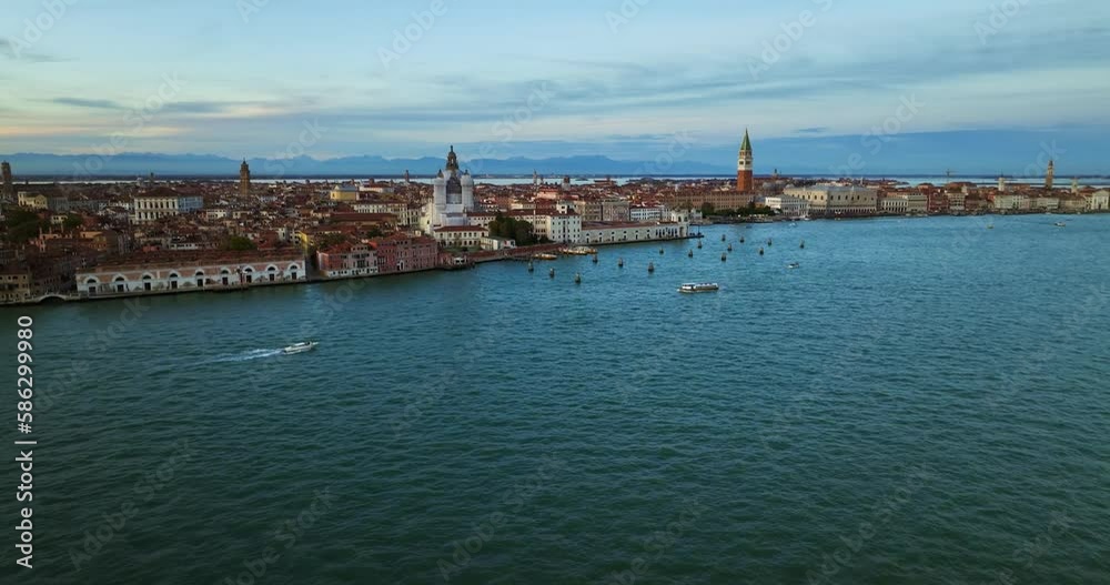 Aerial view of Venice, Italy. Canals and gondolas on lagoon. Panorama City skyline during summer sunset over buildings and Basilica's Aerial view of Venice, Italy. Canals and gondolas on lagoon. Panorama City skyline during summer sunset over buildings and Basilica's