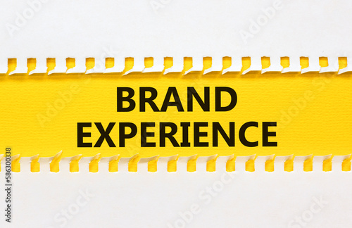 Brand experience symbol. Concept words Brand experience on yellow paper. Beautiful yellow table white background. Business branding and brand experience concept. Copy space.