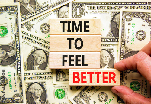 Time to feel better symbol. Concept words Time to feel better on wooden block. Beautiful background from dollar bills. Businessman hand. Motivational business time to feel better concept. Copy space