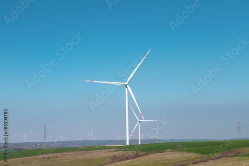 Wind turbine and windmill. Clean energy in green nature in different locations. Sustainability and environment concept

