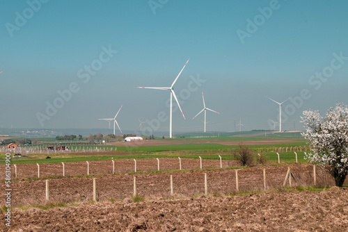 Wind turbine and windmill. Clean energy in green nature in different locations. Sustainability and environment concept
