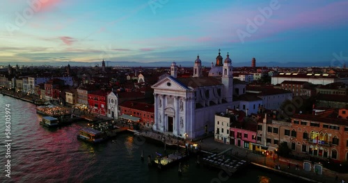 Aerial view of Venice, Italy. Canals and gondolas on lagoon. Panorama City skyline during summer sunset over buildings and Basilica's