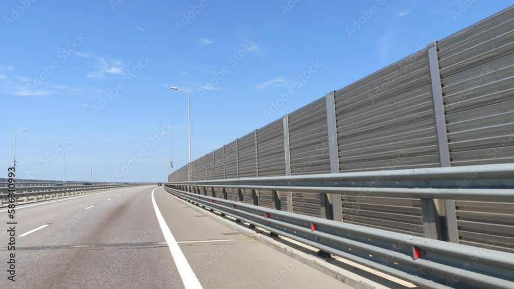 Protective screens along the freeway. Video shooting in motion, the effect of speed, the car is driving on the highway near the fence. Protective screens along the freeway. Video shooting in motion, the effect of speed, the car is driving on the highway near the fence.