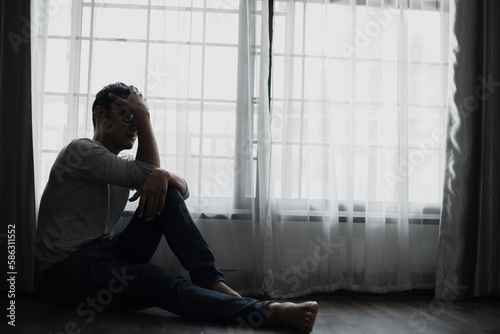 Sad young man in the bedroom, People with depression concept. 