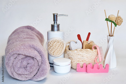 A towel and a set for foot care on a white background. Spa procedures. Close-up