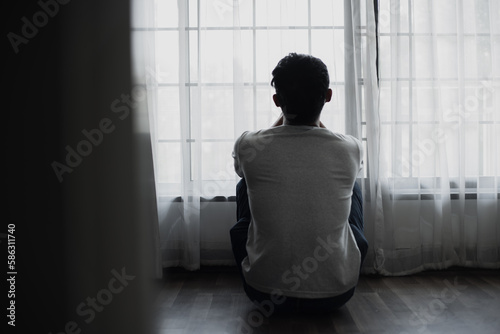 Sad young man in the bedroom, People with depression concept.	
