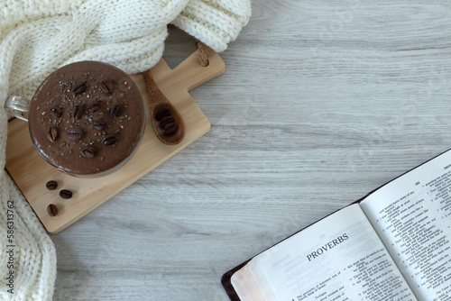 Proverbs open Holy Bible Book on a wooden table with a cup of coffee and a woolen scarf. Top view. Studying Old Testament Scriptures for wisdom by God Jesus Christ. Christian biblical concept.	 photo