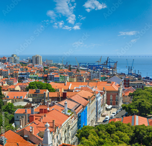 Sea port with cranes view and cityscape from Monastery roof in Lisbon, Portugal.
