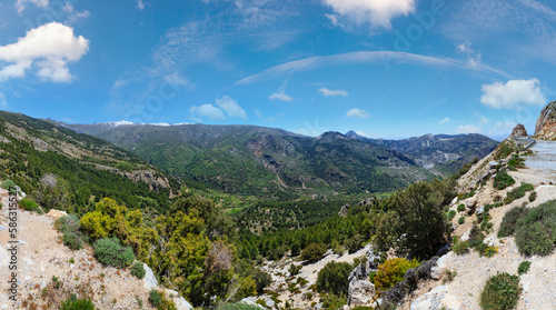 Summer mountain landscape with snow on peak and road (Sierra Nevada National Park, near Granada, Spain).
