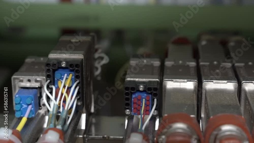 Close up hand held pan of electrical wires and connectors on a 787 commercial airplane.