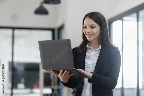 woman using laptop computer at office.