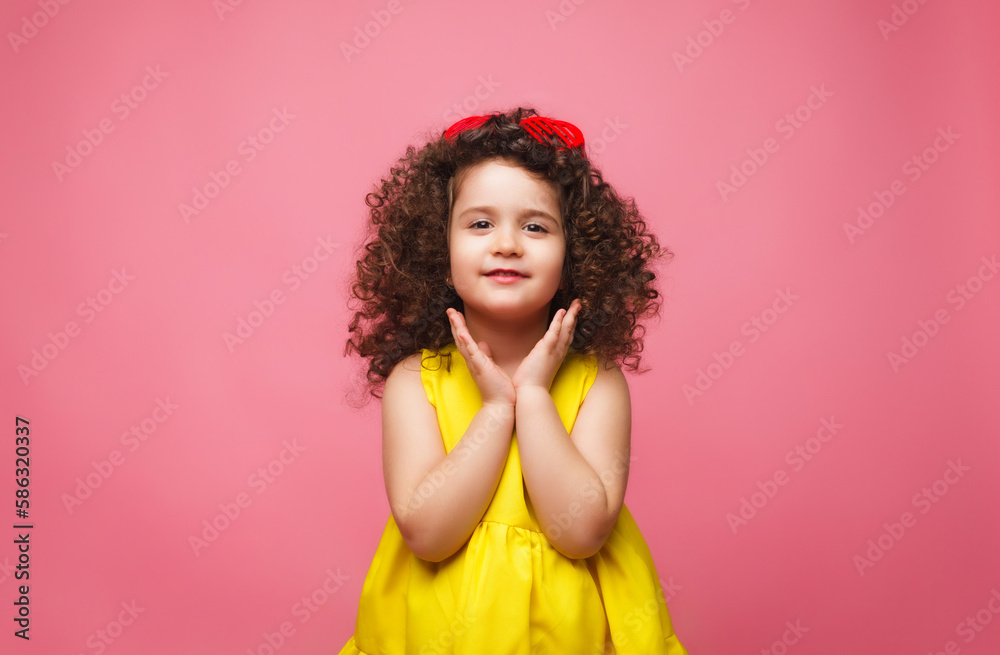 portrait of a girl in a yellow dress cute attractive cute cheerful cheerful little girl .isolated pink background. portrait of a girl in a yellow dress cute attractive cute cheerful cheerful little girl .isolated pink background.