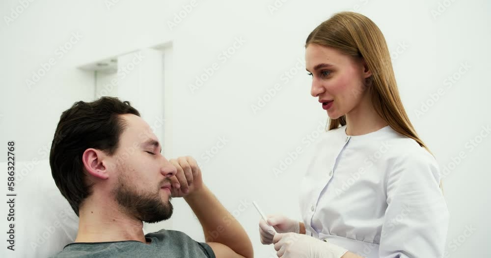 Young bearded man on consultation at beautician or surgeon Young bearded man on consultation at beautician or surgeon