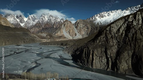 Aerial Pan shot of Passu Cones and Indus river in winters on sunny day. Aerial view of Hunza Valley