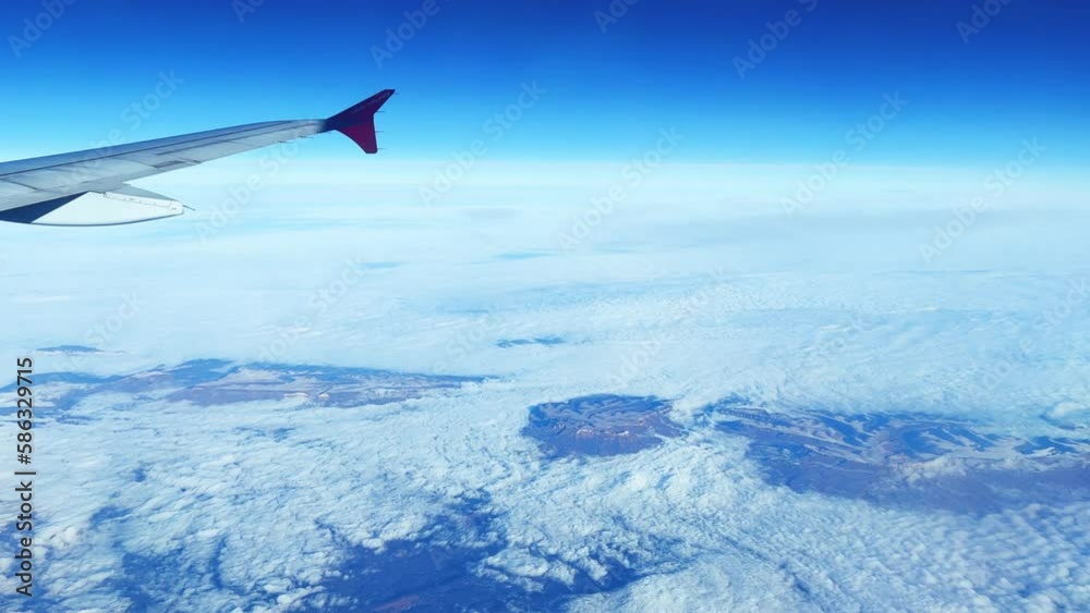 Flying by plane. The wing of an airplane flying above the clouds. View from the plane window. Travel by air. 4K video. Sochi, Russia 2023