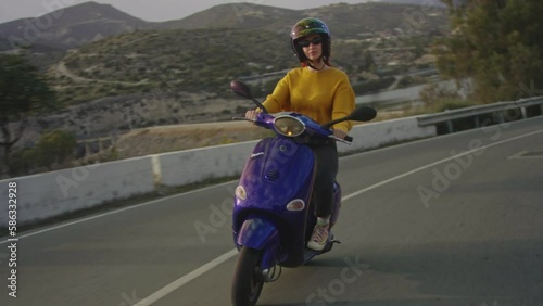 Woman riding electric motorbike while on spring vacation