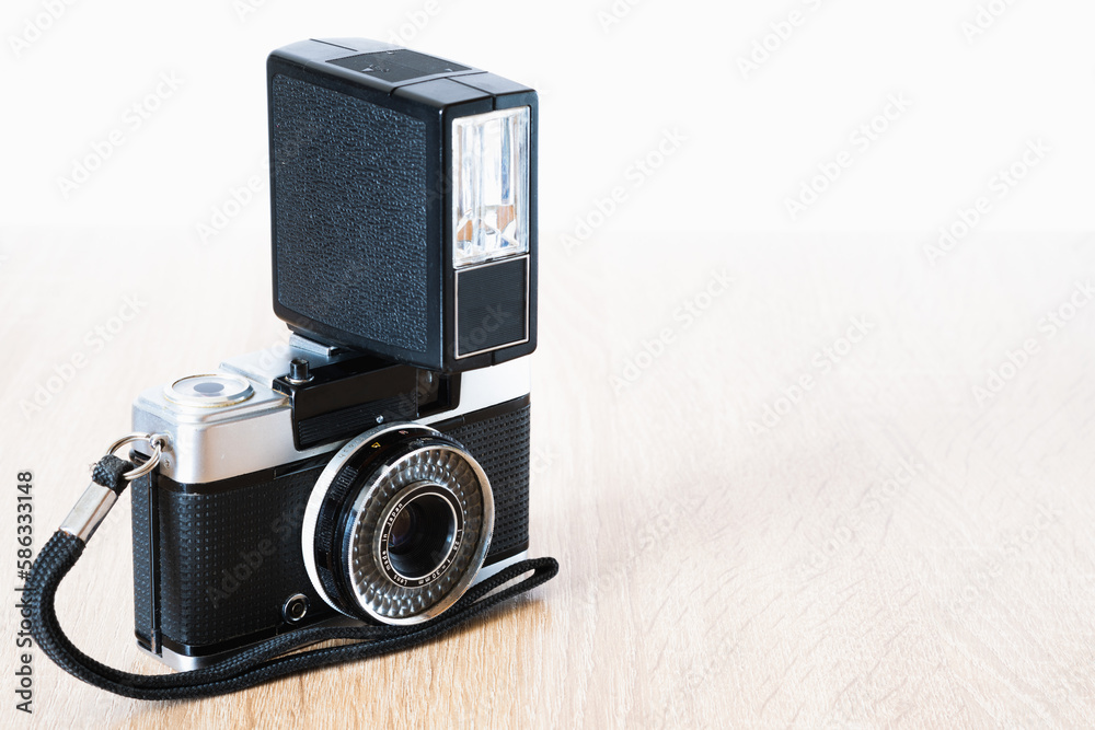 old roll system camera with antique flash on wooden table, photography theme, visual communication, top view
