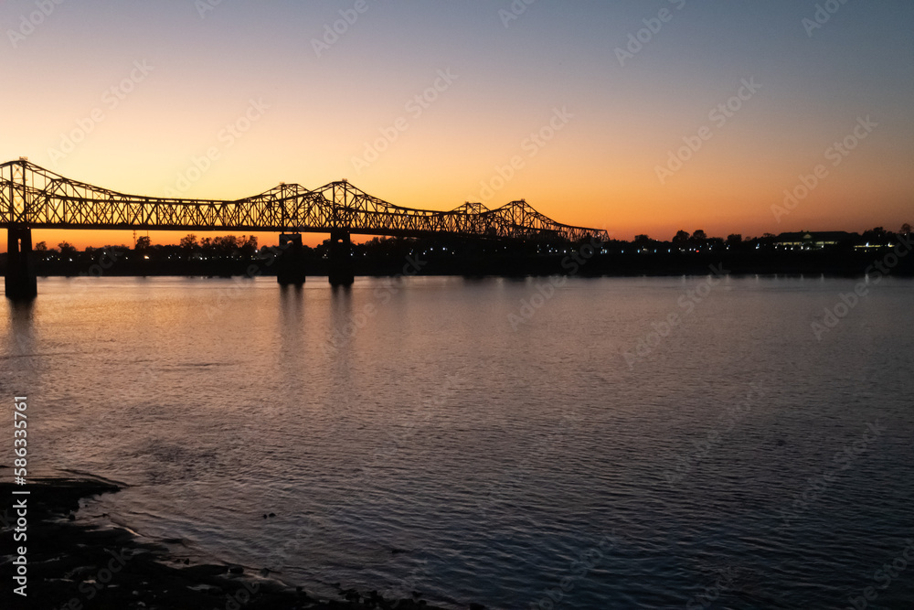Sunset on the Mississippi River in Natchez, Mississippi with the Natchez Vidalia Bridge. Sunset on the Mississippi River in Natchez, Mississippi with the Natchez Vidalia Bridge.