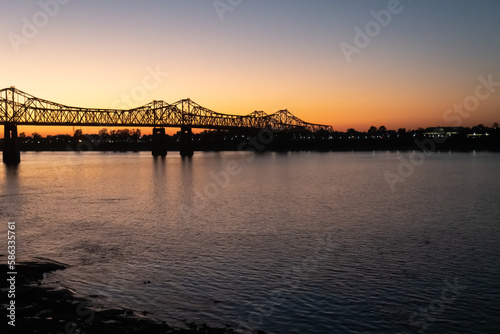 Sunset on the Mississippi River in Natchez, Mississippi with the Natchez Vidalia Bridge.
